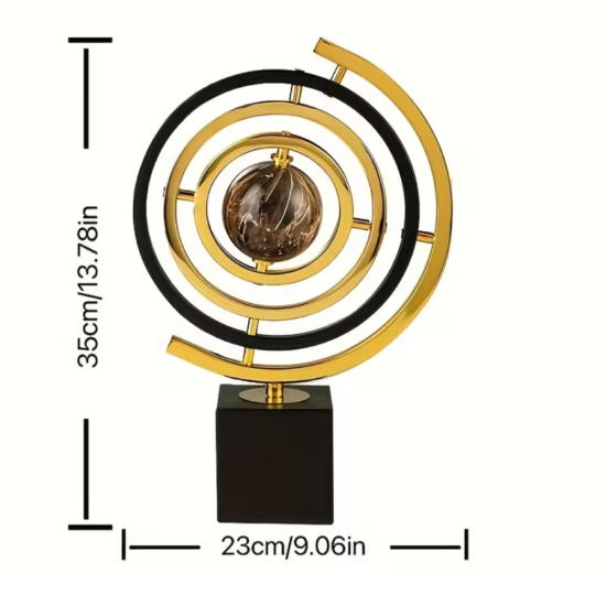 Декоративна армирална сфера от метал в златист и черен цвят, поставена върху масивна квадратна основа от черен мрамор